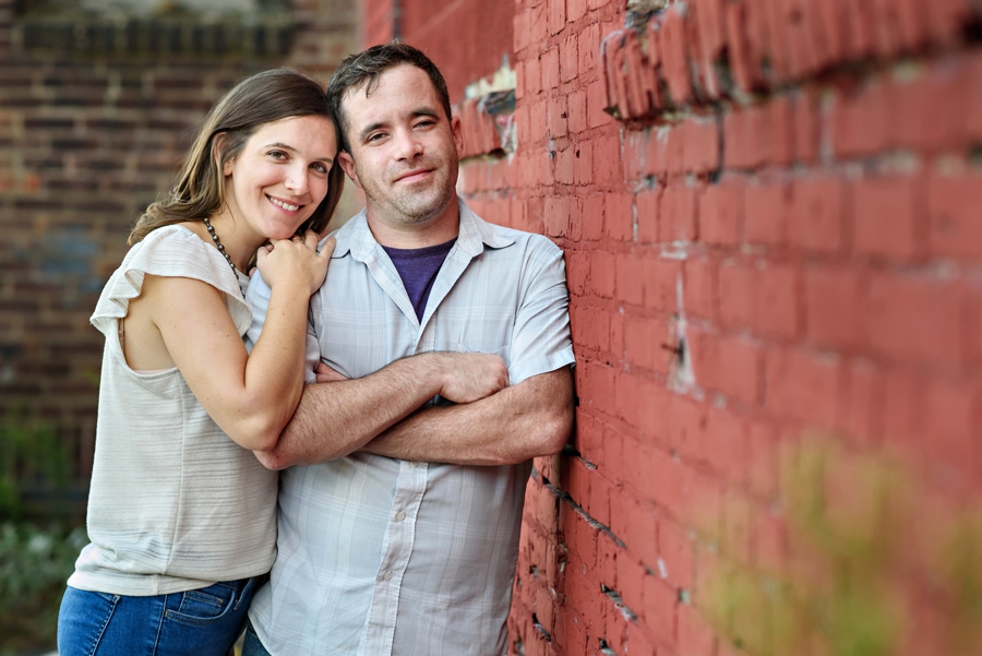 A woman lays her head on her fiance's shoulder in thier fishtown engagement session.